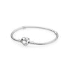 Pandora Moments Sterling Silver Snake Chain Bangle worn on a wrist, showing elegant heart-shaped clasp.