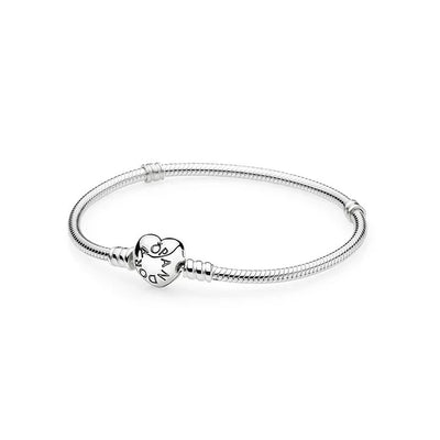 Pandora Moments Sterling Silver Snake Chain Bangle worn on a wrist, showing elegant heart-shaped clasp.